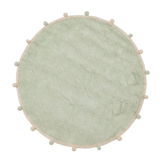 Alfombra infantil redonda con pompones en tono salvia.